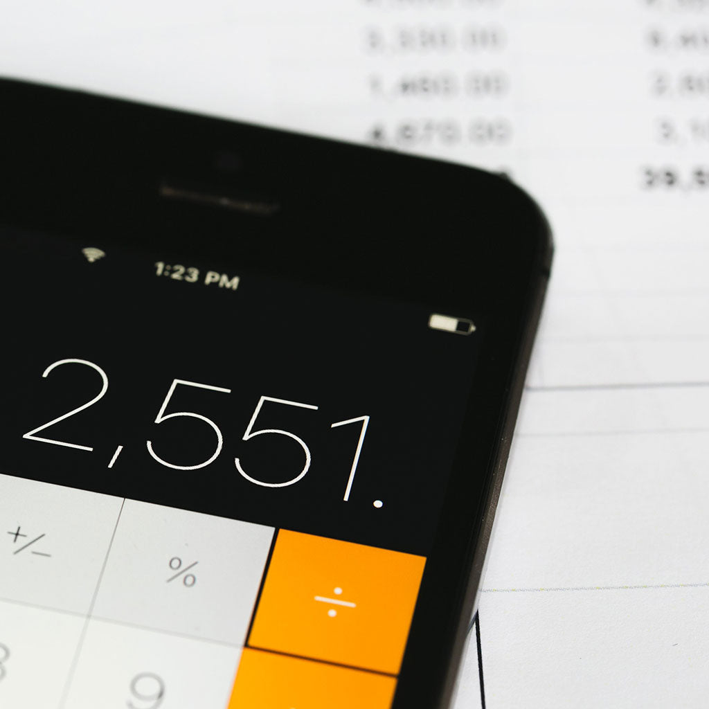 Calculating Time and Bills // Photo by Shopify Partners from Burst